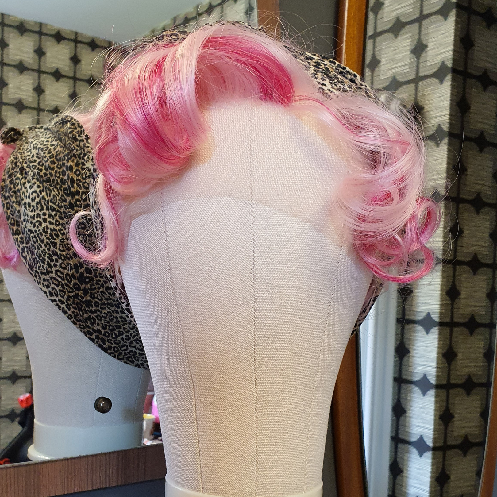 A pink wig styled with a leopard print bandana.